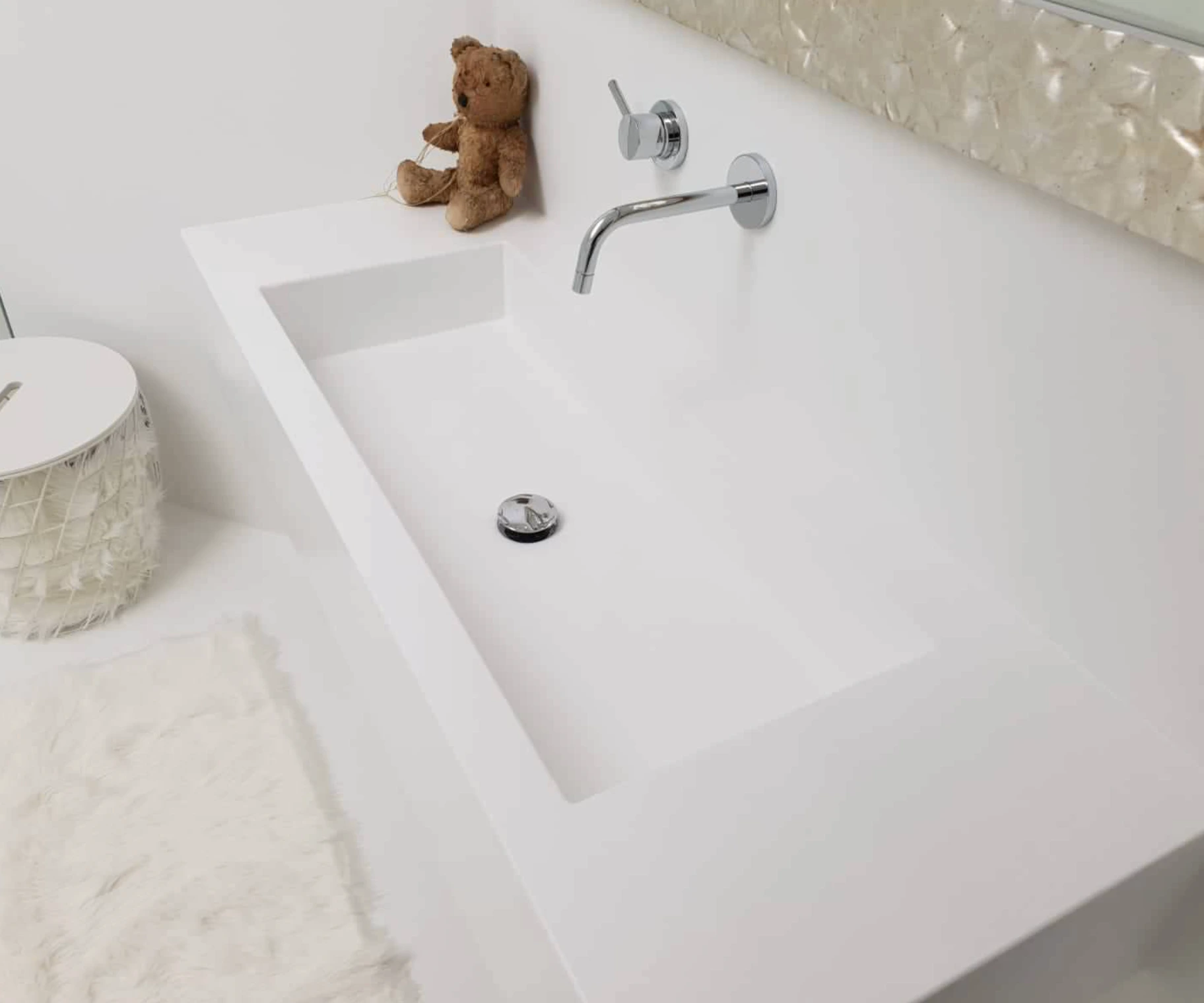 Bathroom detail with an integrated basin and wall-mounted taps.